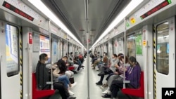 Residents ride public transport in the district of Haizhu as pandemic restrictions are eased in southern China's Guangzhou province, Dec. 1, 2022.