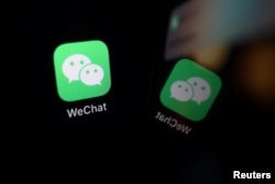 FILE - The sign of the WeChat app is seen reflected on a mobile phone in this illustration picture taken Sept. 19, 2020.