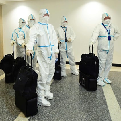 In this file photo taken on December 3, 2021, the flight crew from Air China arrive in hazmat suits in the international terminal at Los Angeles International Airport. The US will require negative Covid tests from all air travelers from China, saying Beijing is not sharing enough information about the surge in coronavirus cases there. Photo: AFP