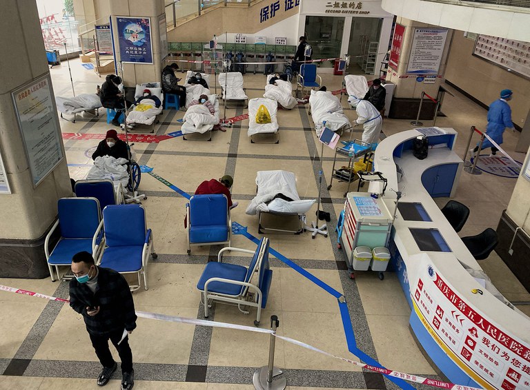 ENG_CHN_COVIDInfections_12222022.3.jpg A man stands in front of a cordoned-off area, where COVID-19 patients lie on hospital beds, in the lobby of the Chongqing No. 5 People's Hospital in China's southwestern city of Chongqing on Friday, Dec. 23, 2022. Credit: AFP