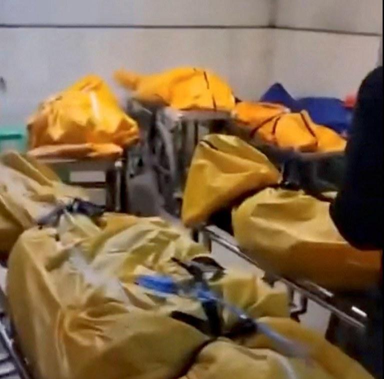 ENG_CHN_COVIDInfections_12222022.2.JPG Several body bags are lined up around the level at a loading bay in a building in Chongqing, China, in this image released Thursday, Dec. 22, 2022. Credit: Reuters screenshot from video