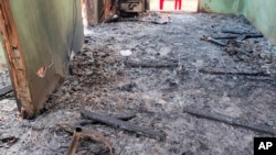 Debris and soot cover the floor of a middle school in Let Yet Kone village in Tabayin township in the Sagaing region of Myanmar on Sept. 17, 2022, the day after an air strike hit the school.