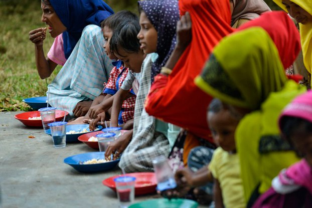 Rohingya refugees eat at a temporary shelter following their arrival by boat in Laweueng, in Indonesia's Aceh province, Dec. 27, 2022. Credit: AFP