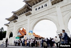 Taipei residents gather at the capital's Liberty Square in support of China's lockdown protests, in Taipei, Dec. 4, 2022.