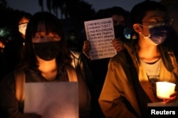 FILE - People gather to support protests in China regarding the coronavirus disease (COVID-19) restrictions at National Taiwan University in Taipei, Nov. 30, 2022.