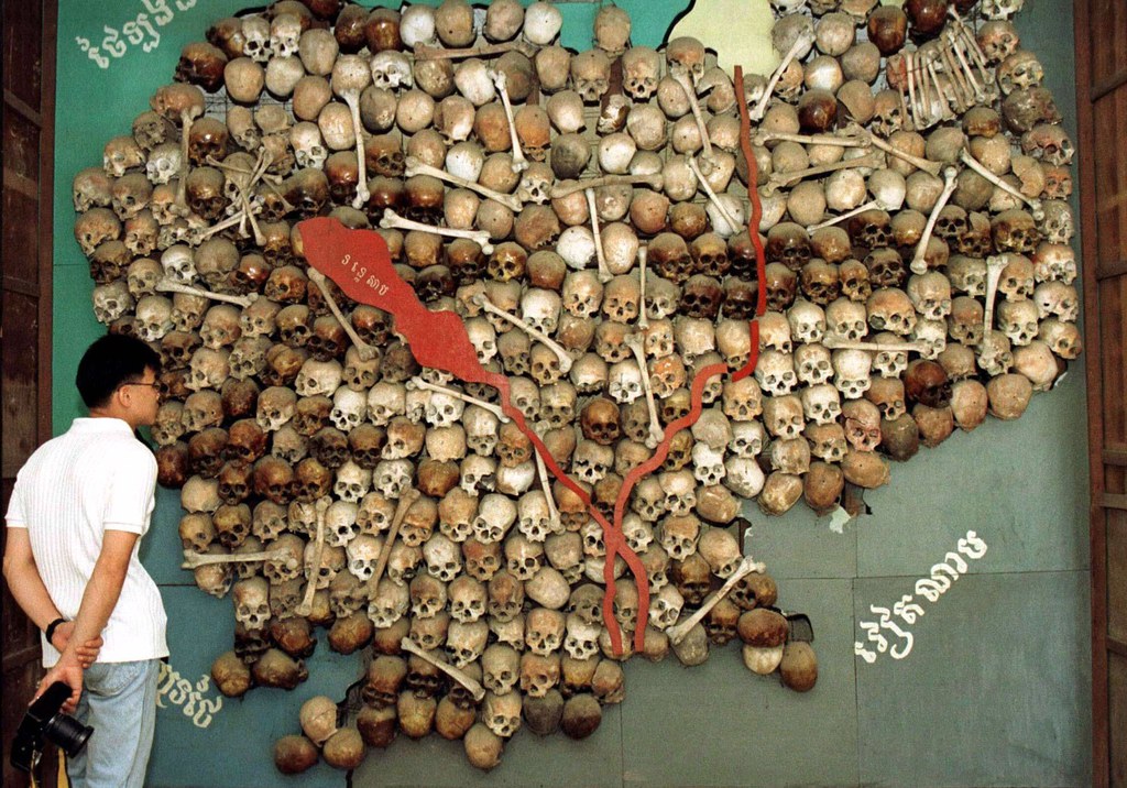 ENG_KHM_THAYER_Q&A_01072023.5.JPG A visitor stands before a map of Cambodia made from the skulls and bones of victims of the Khmer Rouge's brutal 1975-79 "killing fields" regime at Tuol Sleng in Cambodia, June 23, 1997. Credit: Reuters