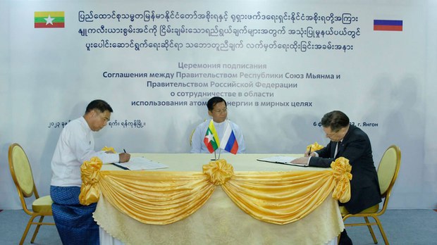 Military junta chief Senior Gen. Min Aung Hlaing watches the signing of the agreement between Myanmar and Russia for nuclear cooperation by the junta’s Minister for Science and Technology Myo Thein Kyaw [left] and Alexey Likhachev, CEO of Russia’s Rosatom state nuclear agency, on Monday, Feb. 6, 2023, in Yangon. Credit: Myanmar military