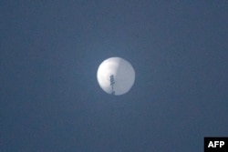 This photo from Chase Doak taken on Feb. 1, 2023, and released on Feb. 2 2023, shows a suspected Chinese spy balloon in the sky over Billings, Montana.