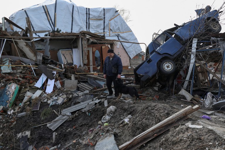 ENG_CHN_Xi-Putin_03212023.3.JPG Local resident Volodymyr Alipov, 58, pets a dog amid the remains of his house destroyed last year by a Russian airstrike on the village of Tsyrkuny, Kharkiv region, Ukraine, Monday, March 20, 2023. The United States and its allies are wary of Chinese leader Xi Jinping’s 12-point peace plan for Ukraine. Credit: Reuters