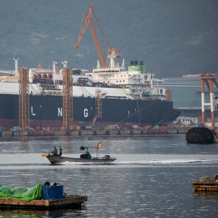 A fishing boat sails past liquefied natural gas (LNG) tankers under construction at the Daewoo Shipbuilding &amp; Marine Engineering Co. shipyard in Geoje, South Korea, on Friday, June 5, 2020. Qatar has signed a deal worth around $20 billion with South Korean shipbuilders to help cement its position as the world’s largest producer of liquefied natural gas. Photographer: SeongJoon Cho/Bloomberg