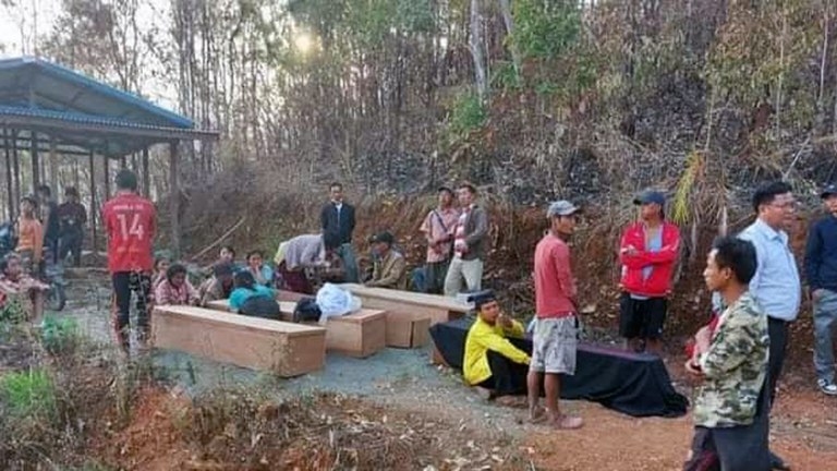 ENG_BUR_ChinAirstrikes_04272023_03.JPG Families sit next to the coffins of victims of Myanmar military junta's airstrike in Webula town, Chin state, on April 11, 2023. Credit: Citizen Journalist