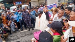 Veteran Sherpa guide Kami Rita, center, arrives at the airport in Kathmandu, Nepal, May 25, 2023.