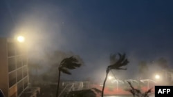 This video grab from the Twitter page of James Reynolds @EarthUncutTV shows strong winds and precipitation from Typhoon Mawar blowing across Tumon Bay, Guam on May 24, 2023.