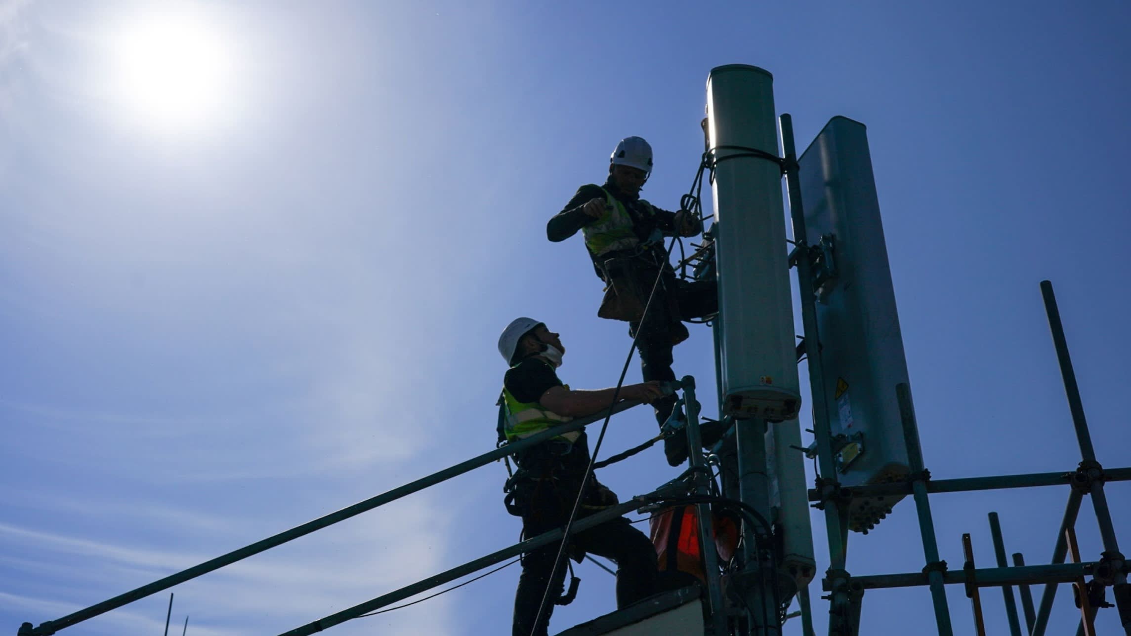 Engineers work on network antenna