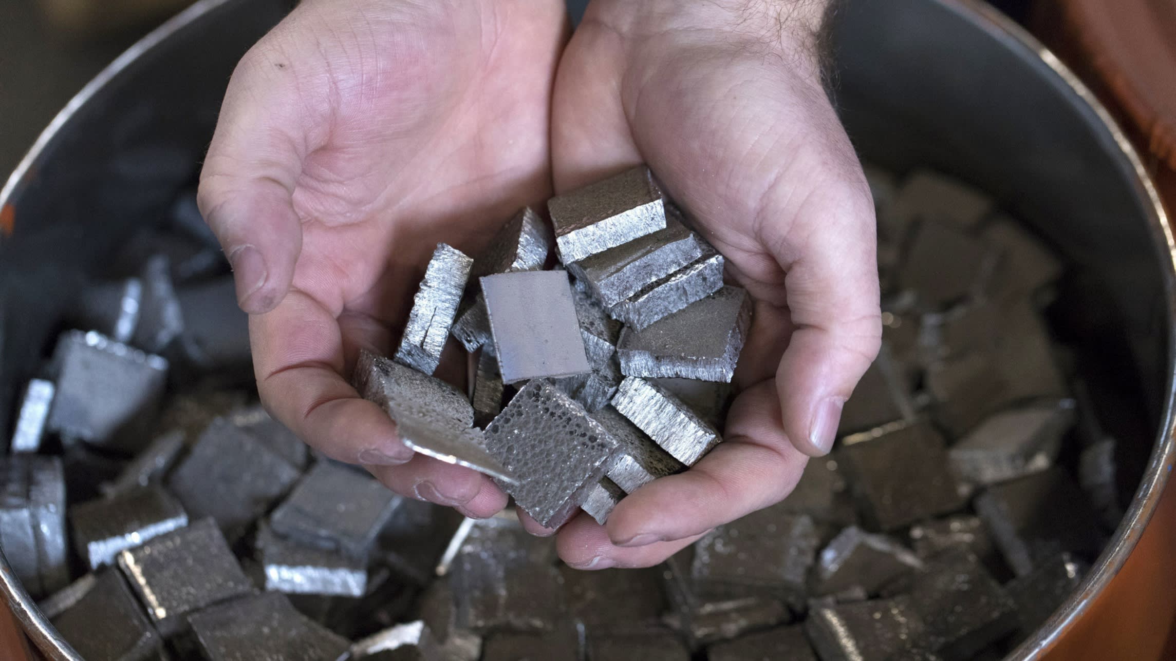 Cut cobalt cathodes are held over a barrel