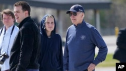 President Joe Biden and his granddaughter Maisy Biden stretch their legs during a refueling stop at Elmendorf Air Force Base in Anchorage, Alaska, May 17, 2023.
