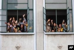 Supporters of Move Forward Party wave to party leader Pita Limjaroenrat, in Bangkok, May 15, 2023.