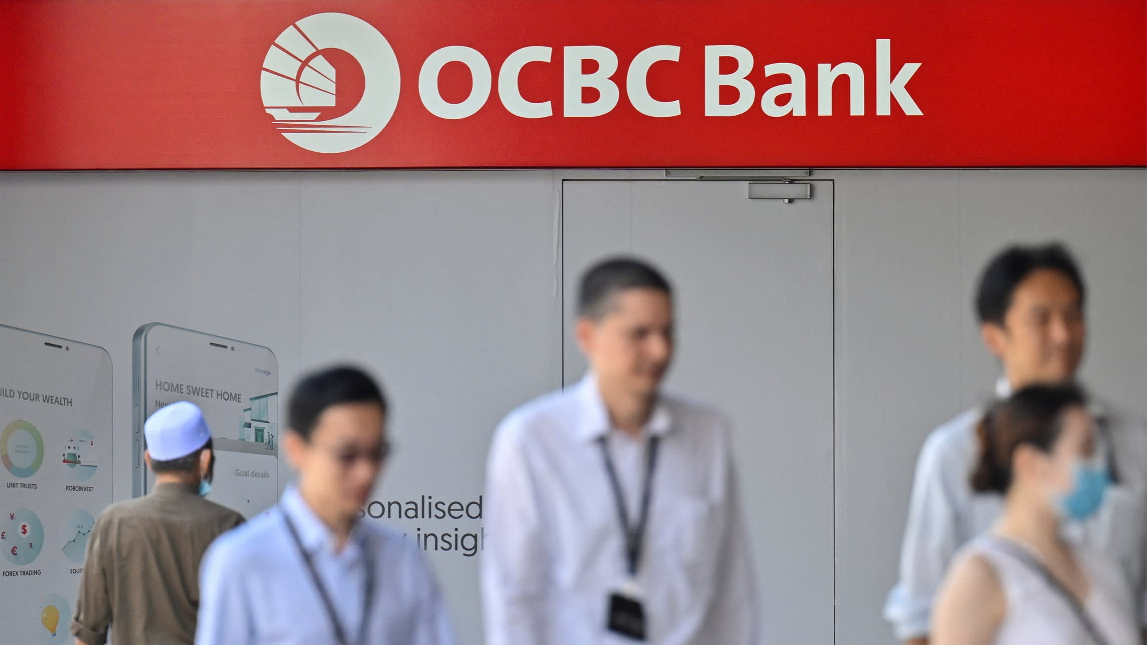People pass an OCBC bank office in Singapore