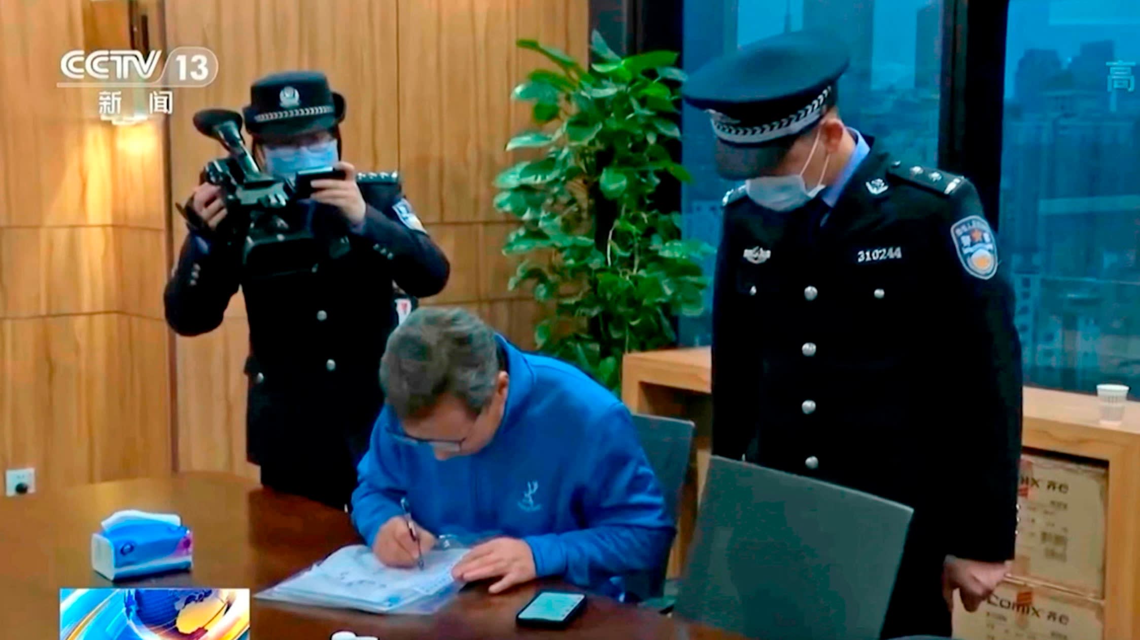 In this image taken from undated video footage run by China’s CCTV, Chinese police conduct law enforcement work during a raid at the Capvision office in Shanghai