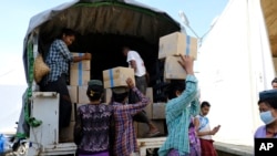 This image provided by the World Food Program shows relief food commodities being stockpiled at WFP warehouses in Rakhine State, May 14, 2021.