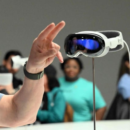 Apple chief executive Tim Cook gestures to members of the media next to the new Vision Pro mixed-reality reality headset during the company’s Worldwide Developers Conference, held at the Apple Park campus in Cupertino, California, on June 5, 2023. Photo: Agence France-Presse