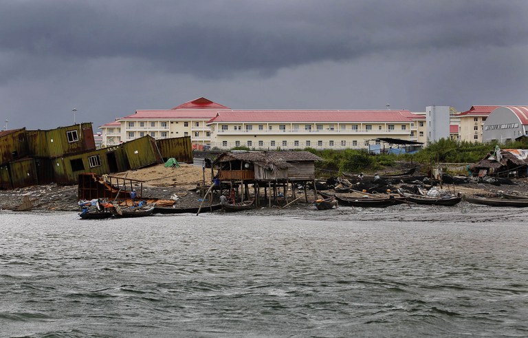 ENG_BUR_ChinaRakhinePort_06012023_02.jpg Local fishermen’s houses and boats at the foreground of the Chinese oil pipeline project building on Maday island, Kyaukpyu township, Rakhine state, Myanmar Oct. 7, 2015. Credit: Soe Zeya Tun/Reuters