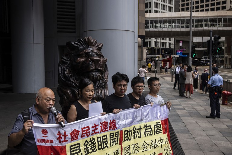 Veteran activist Tsang Kin-Shing [left], a member of the “League of Social Democrats,” speaks during a protest outside the headquarters of The Hong Kong and Shanghai Banking Corporation Limited (HSBC) in Hong Kong on Tuesday, June 6, 2023. Credit: AFP