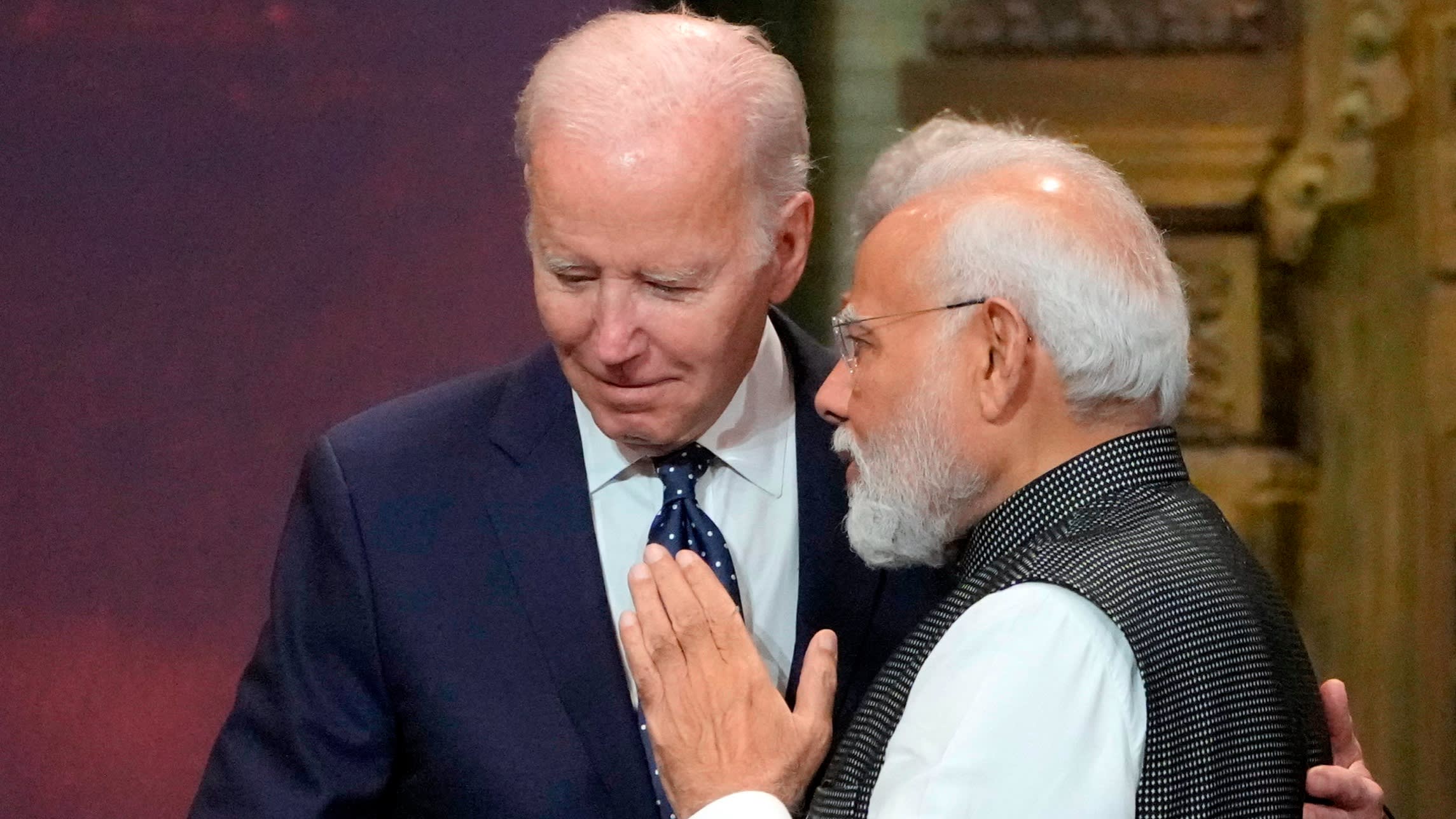 Joe Biden leans closer to Narendra Modi as they talk