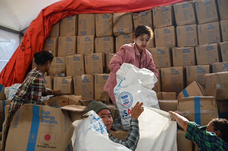 ENG_BUR_AidRakhine_06082023_04.jpg Workers sort through food at a damaged UN World Food Program warehouse in Sittwe in the aftermath of Cyclone Mocha's landfall. Myanmar’s junta on Thursday issued a blanket ban on transportation for aid groups operating in Rakhine state only a day after State Government granting them permission to assist victims. Credit: Sai Aung Main/AFP