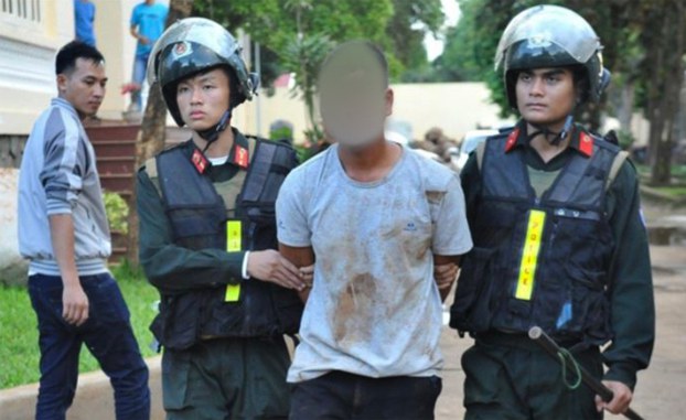 ENG_VTN_PoliceAttack_06152023.2.jpg Vietnamese police officers escort a suspect arrested in Dak Lak province. Credit: Vietnamese State media