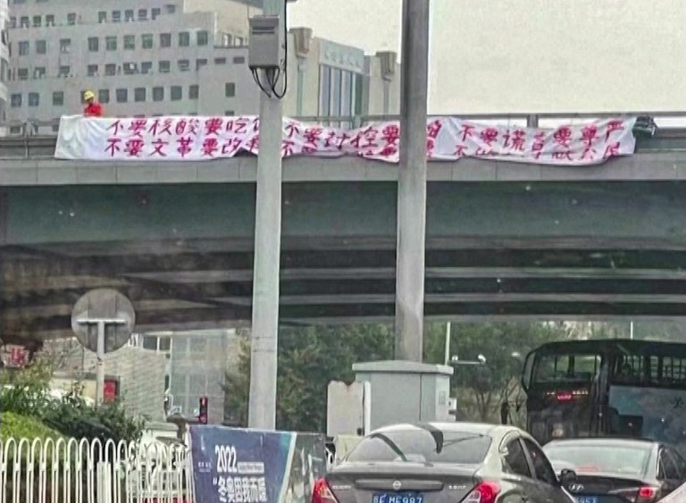ENG_CHN_ChengduSecurity_07262023.2.jpg A protester hangs two banners off a Beijing overpass on Oct. 13, 2022. Credit: Screenshot from Reuters video