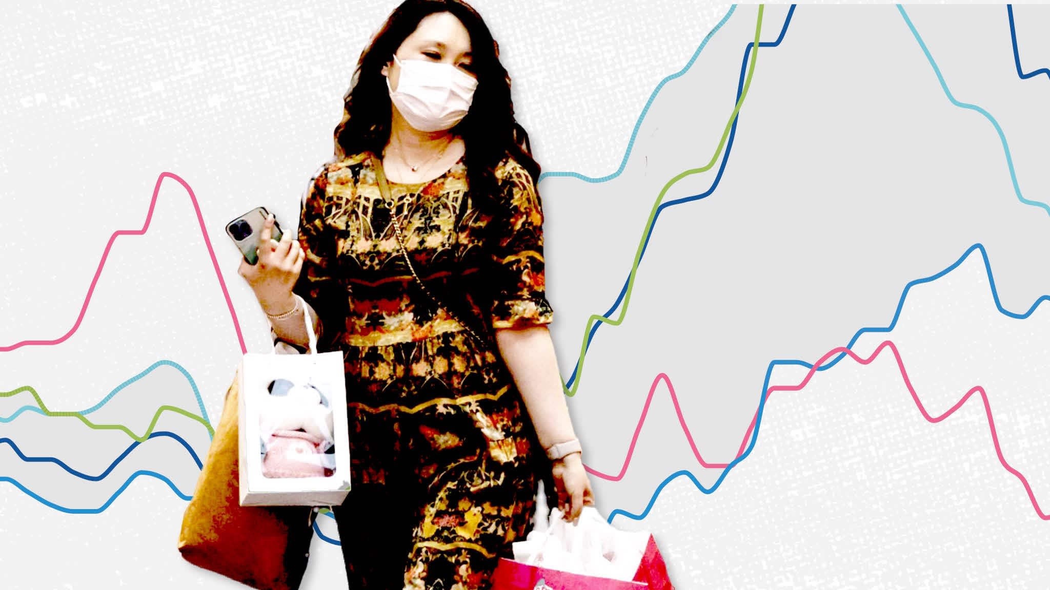 A woman carrying shopping bags with a line chart in the background