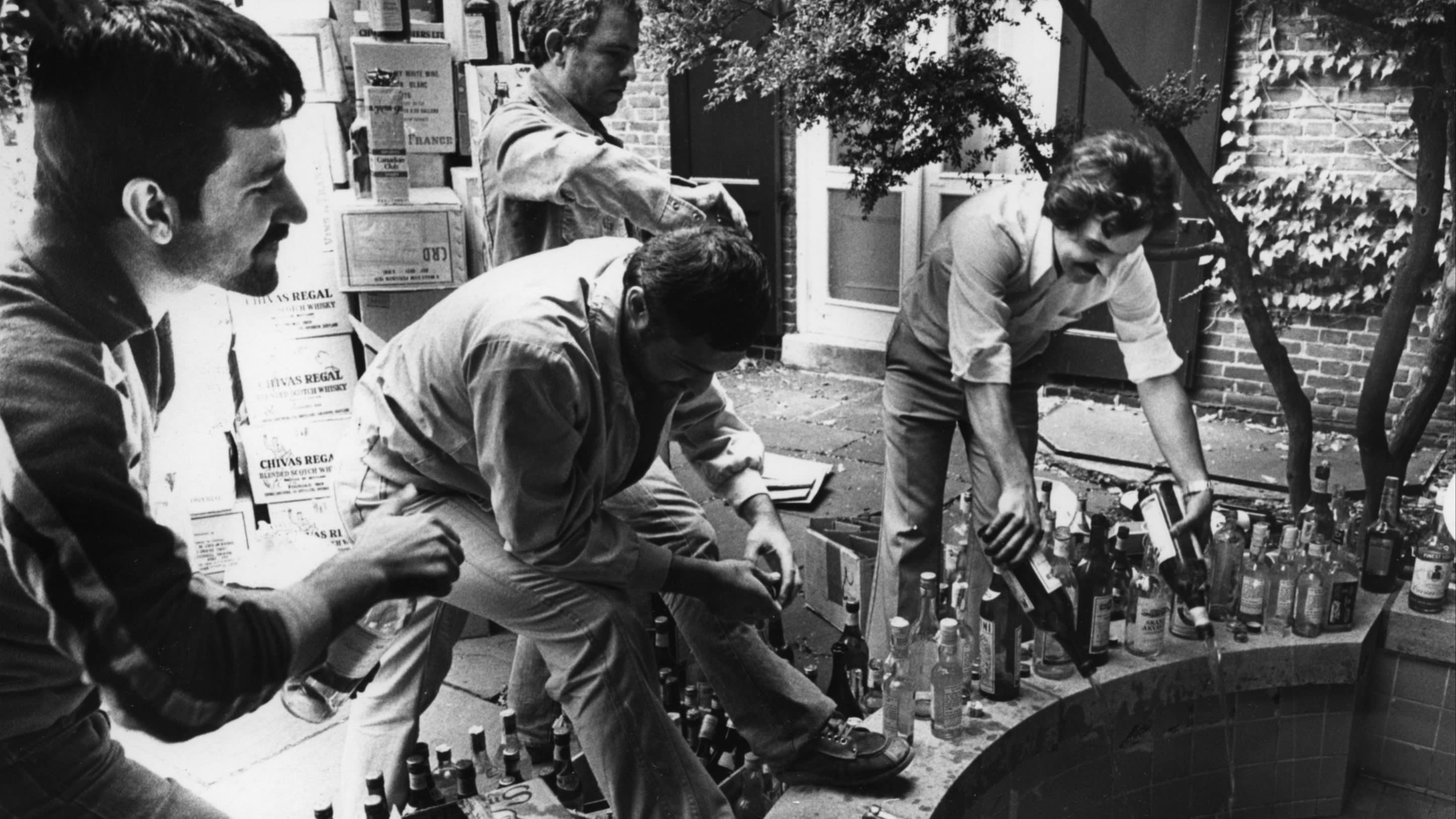 Iranians pour bottles of alcohol into a fountain in Washington, DC