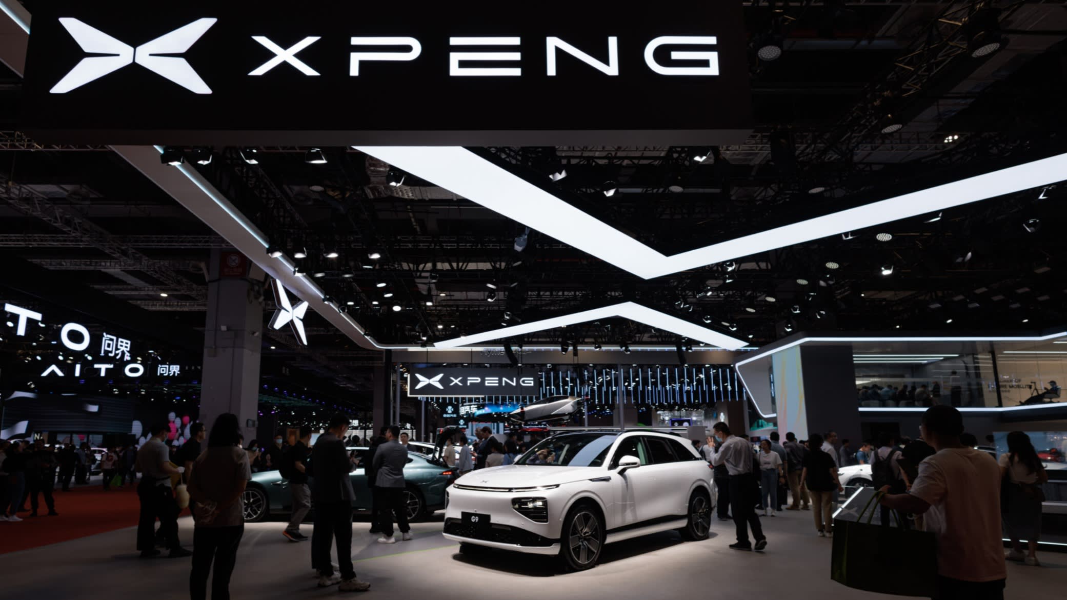 Cars stand on display at the Xpeng company booth at an auto show in Shanghai last week