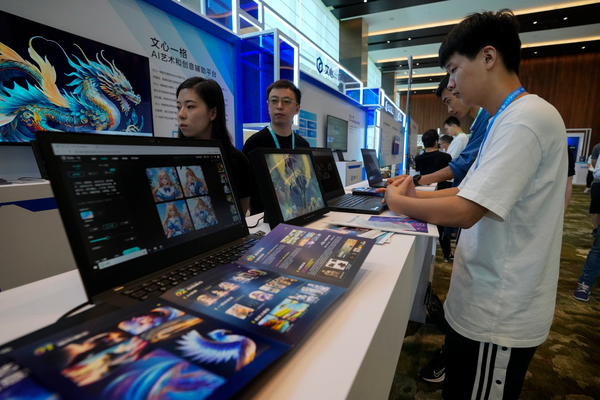 Visitors try out Baidu’s Ernie Bot on laptop computers at the Wave Summit in Beijing on August 16. Photo: AP Photo