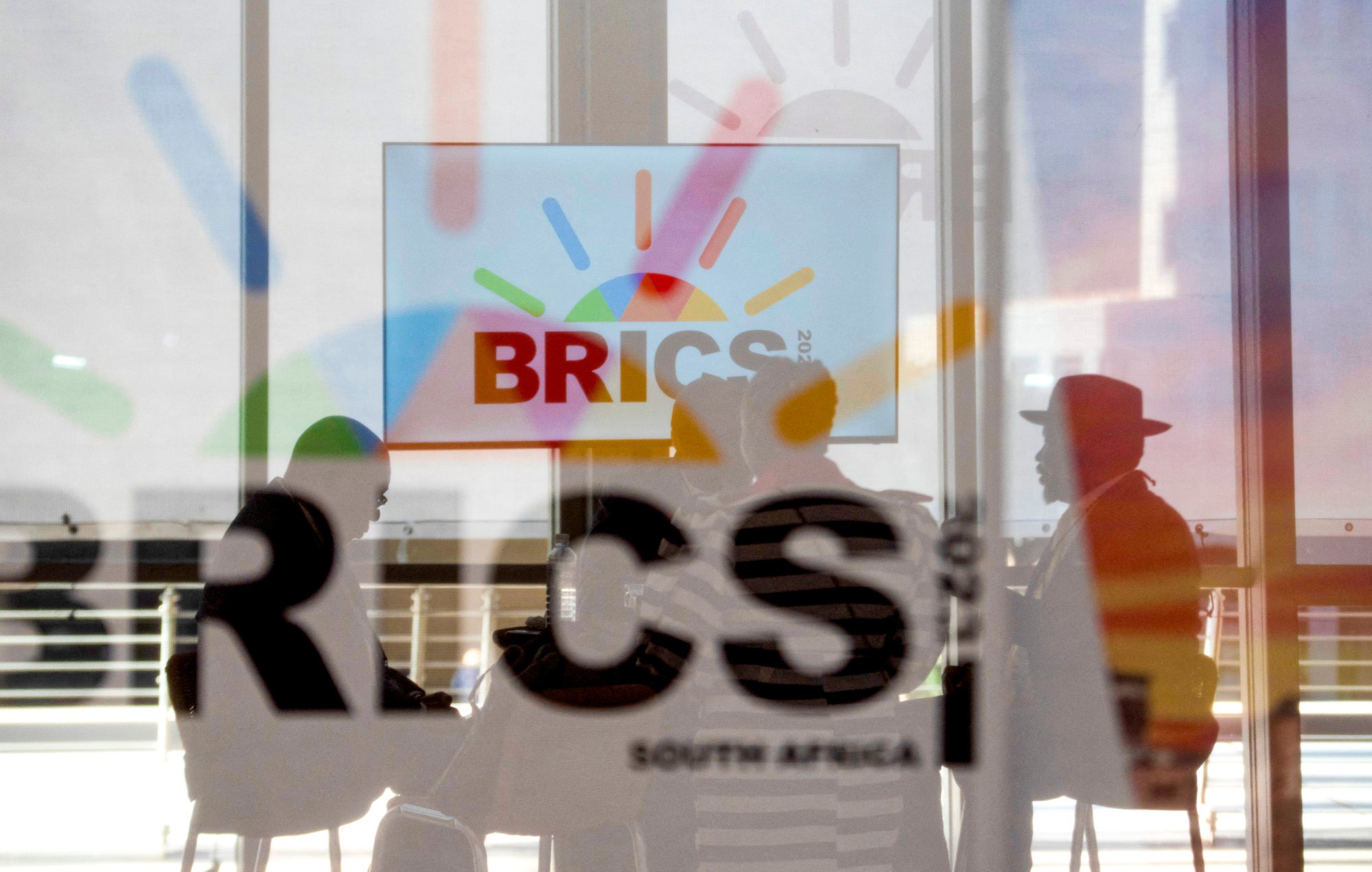South African delegates sit behind a glass with the Brics logo during the Brics summit in Johannesburg, South Africa, on August 23. Photo: Reuters