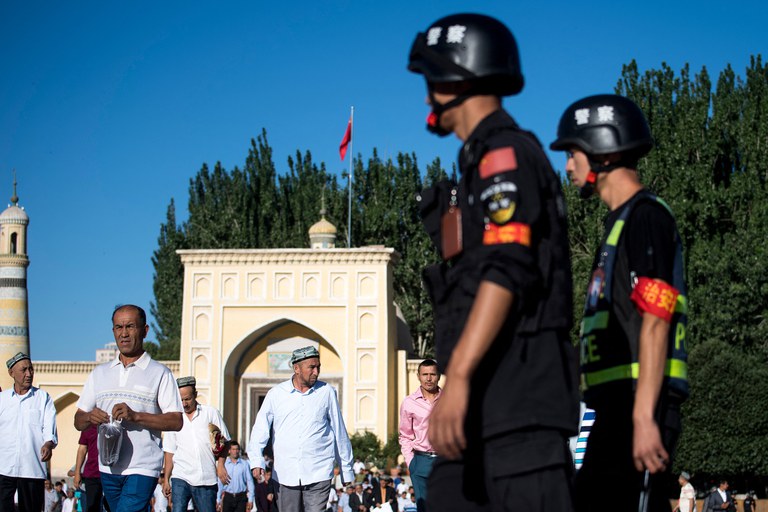 ENG_CHN_CensoredSermons_08032023.2.jpg Police patrol as Muslims leave the Id Kah Mosque after the morning prayer on Eid al-Fitr in the old town of Kashgar in China's Xinjiang Uyghur Autonomous Region, June 26, 2017. Ben Dooley/AFP