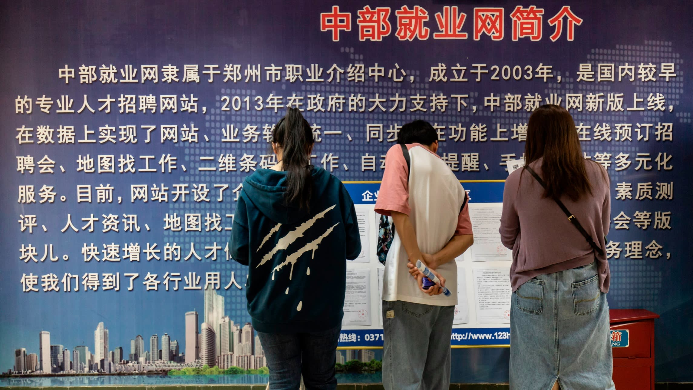 People look at postings at a job placement centre in China