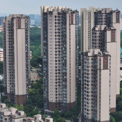 The China Evergrande Group logo is seen on residential buildings in Nanjing, in eastern Jiangsu province, on August 18. The embattled Chinese property giant filed for bankruptcy protection in the United States on August 17, court documents showed, a measure that protects its US assets while it pursues a restructuring deal. Photo: AFP