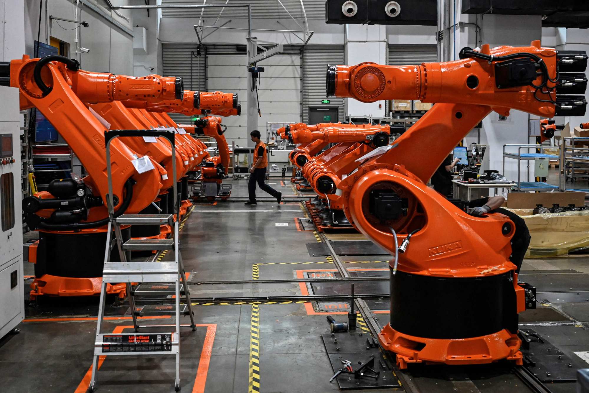 Robotic arms made by the industrial robot manufacturer Kuka, owned by the Chinese home appliances giant Midea Group in Foshan, in China’s southern Guangdong province, on July 7, 2022. Photo: Agence France-Presse