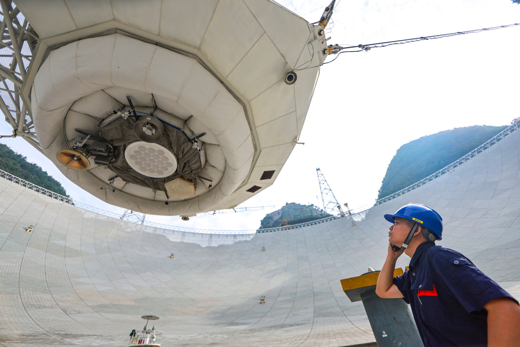A member of staff walks under the feed cabin of FAST in China’s Guizhou province. Photo: Xinhua