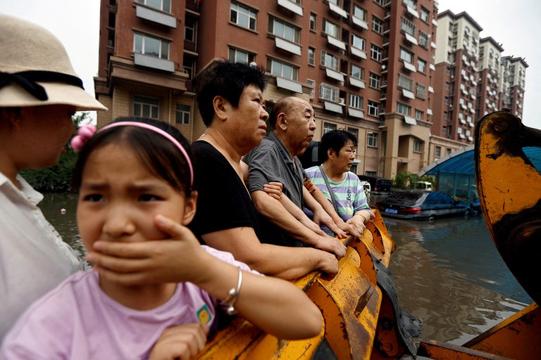ENG_CHN_BeijingFloods_08042023.2.JPG People stand on a front loader as they’re evacuated from a flooded residential compound after flooding brought by remnants of Typhoon Doksuri, in Zhuozhou, Hebei province, China, Aug. 3, 2023. Credit: Tingshu Wang/Reuters
