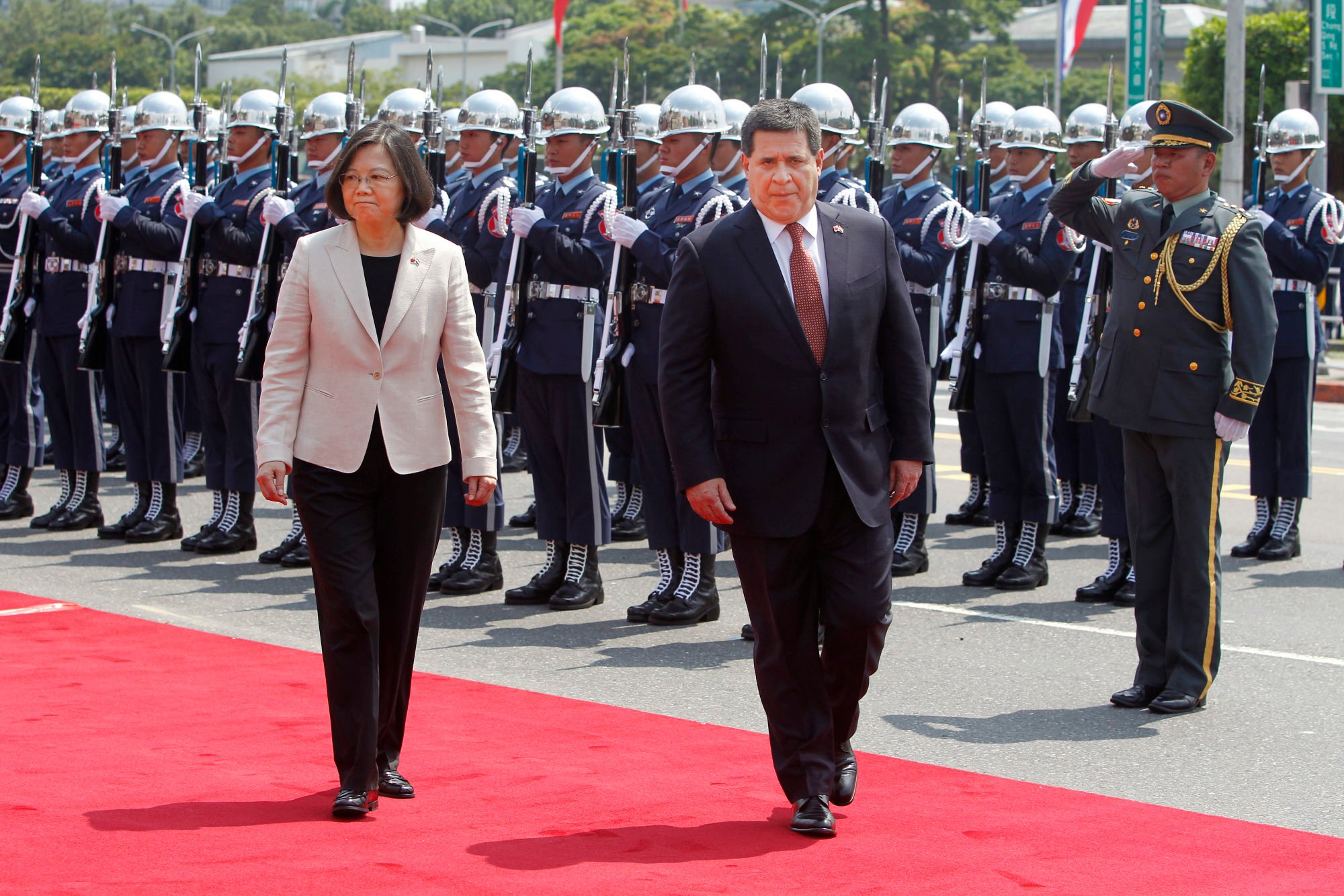 Former Paraguayan president Horacio Cartes (right) reviews an honour guard with Taiwanese leader Tsai Ing-wen in Taipei on July 12, 2017. Cartes faces US sanctions over allegations of corruption. Photo: AP