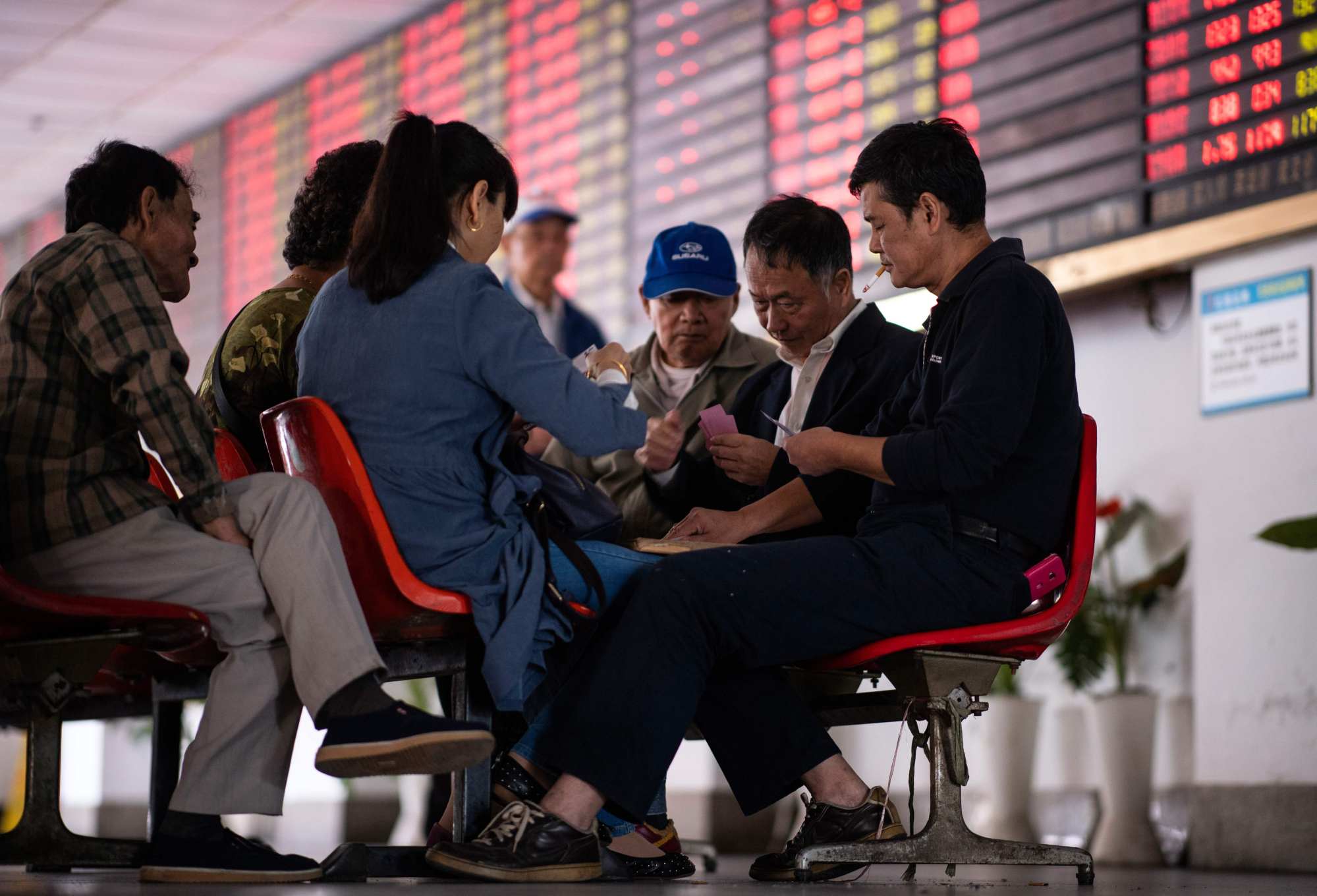 Investors play cards at a brokerage house in Shanghai in 2018. Photo: AFP
