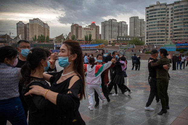 ENG_UYG_OICDelegation_08232023.4.jpg People dance to music at a public square in Aksu in western China's Xinjiang Uyghur Autonomous Region, as seen during a government organized trip for foreign journalists, April 20, 2021. China has focused on promoting its narrative on Xinjiang that includes happy Uyghurs living stable lives. Credit: Mark Schiefelbein/AP
