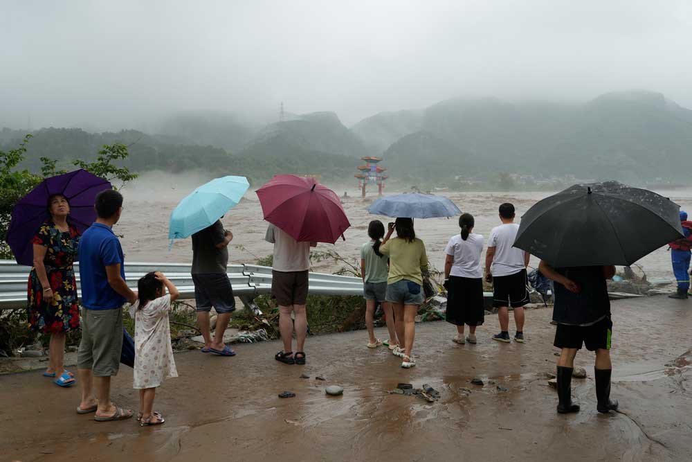 embed2.jpg Residents watch floodwaters inundate an area in Miaofengshan on the outskirts of Beijing, Tuesday, Aug. 1, 2023. Credit: Ng Han Guan/AP