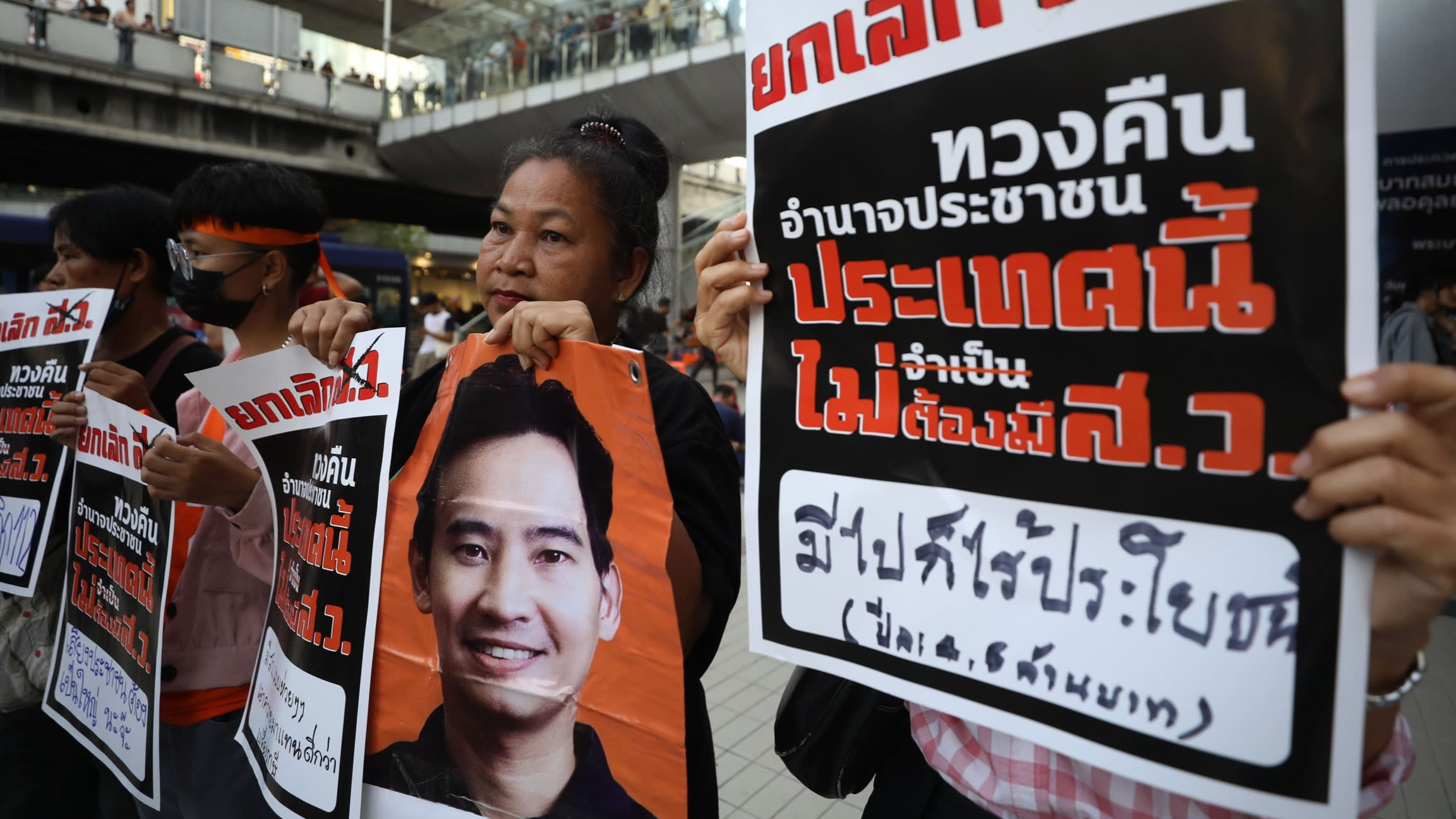 Supporters hold a picture of prime ministerial candidate Pita Limjaroenrat after he was blocked from power by Thailand’s national assembly