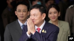 Thailand's former Prime Minister Thaksin Shinawatra, center, with his son Phantongtae and his daughter Pinthongta, arrives at Don Muang airport in Bangkok, Thailand, Aug. 22, 2023.