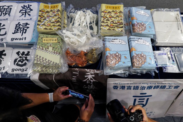 ENG_CHN_UKSheep_08072023.4.jpg Members of the media take photos of evidence on display, including children's books trying to explain the city's democracy movement, at a police press conference in Hong Kong, after five members of a pro-democracy Hong Kong union were arrested for sedition for publishing the titles, July 22, 2021. Credit: AFP
