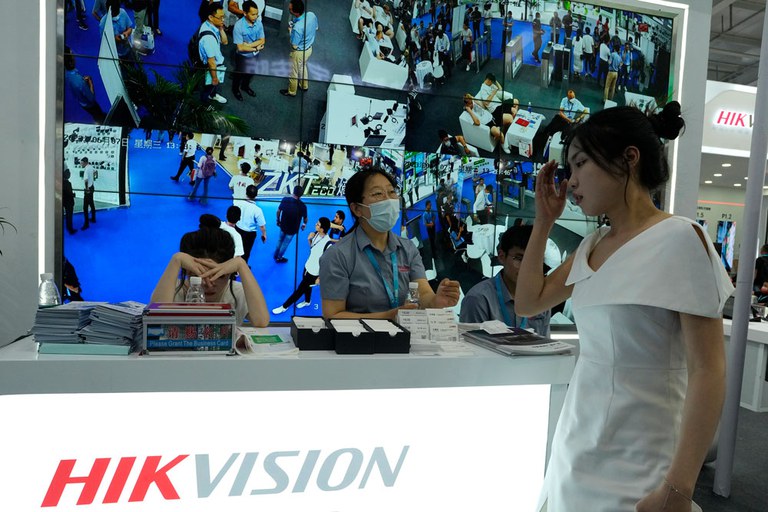 ENG_CHN_Belt_Road10Years_09252023-2.jpg Staffers wait for visitors under a display of CCTV images at the Hikvision booth, a state-owned surveillance equipment manufacturer, during Security China 2023 in Beijing, June 7, 2023. Credit: Ng Han Guan/AP